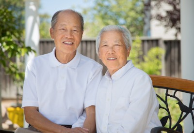 Elderly couple close to each other and smiling