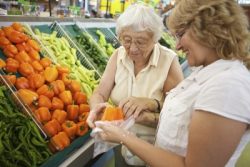 Home care caregiver helping senior with her shopping_s