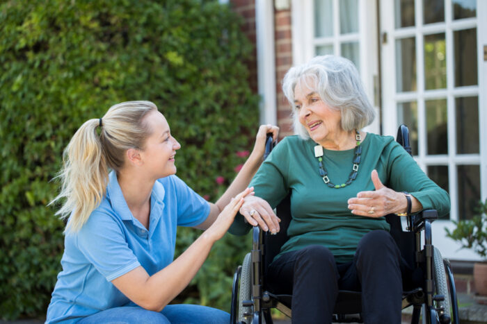 Family caregiver supporting a senior during hospital recovery