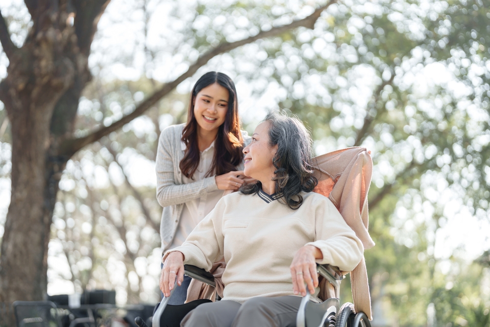 Caregiver assisting senior with mobility to prevent falls at home