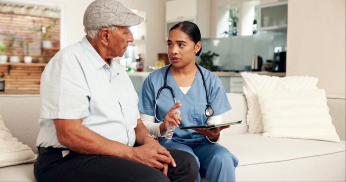 Caregiver supporting a senior managing a chronic health condition