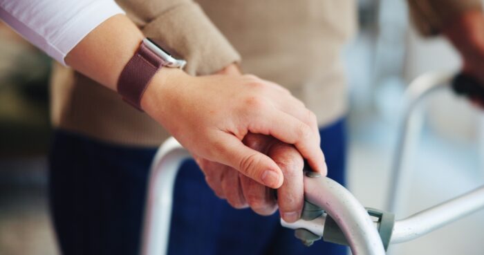 Caregiver assisting a client with Parkinson's disease at home